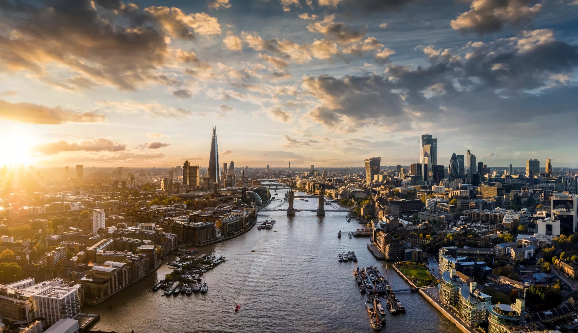 A panoramic view of the city of London with a sunset